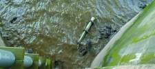 View of original stilling tube with broken section in river below